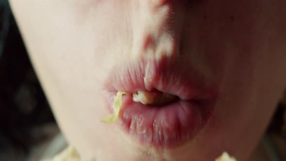 Closeup Bite of a Hungry Woman with Braces on Her Teeth Greedily Bites Her Hamburger Eats a