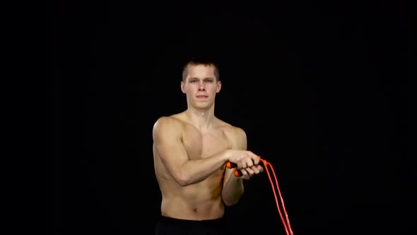 Man Uses a Jump Rope in the Workout. Black