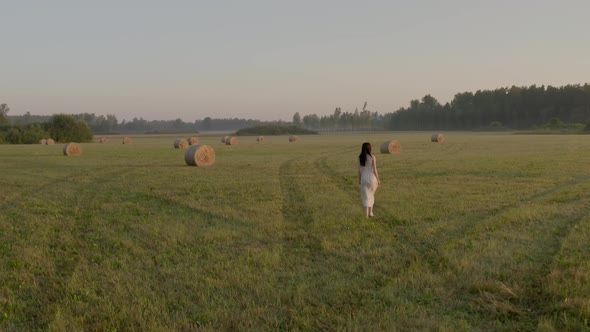 Woman and Hay Roll Field