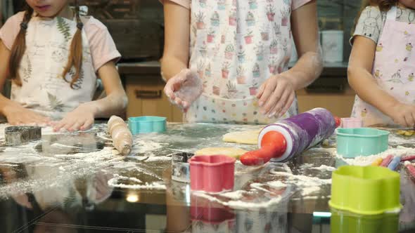 Girls playing with dough and making cookies