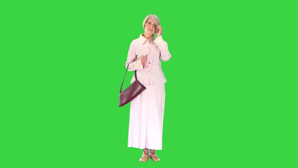 Old Woman Lady in Pink Dress Standing and Waiting on a Green Screen Chroma Key