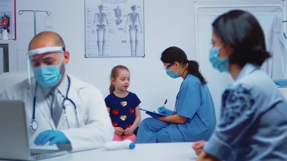 Nurse Writing Child Data on Clipboard