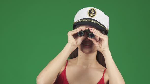 Young Beautiful Happy Woman Smiling Looking To the Camera Through Binoculars