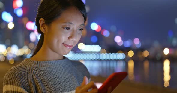 Woman use of mobile phone at night