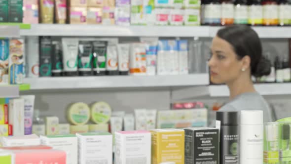 Beautiful Woman Examining Products on Sale at Local Drugstore