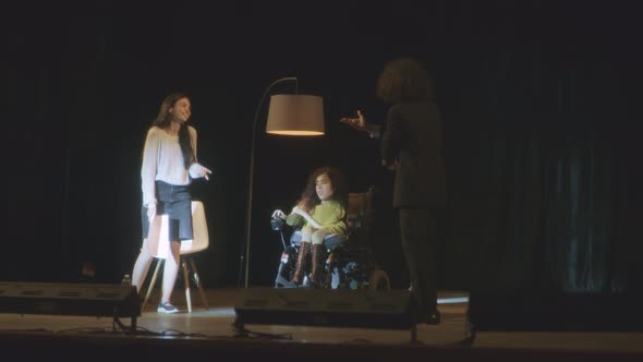 Cast with Disabled Woman on Theatre Stage