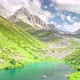 Fast moving clouds over a turquoise alpine lake - VideoHive Item for Sale