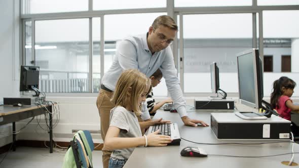 Girl Sitting at Table Looking at Keyboard with Surprise