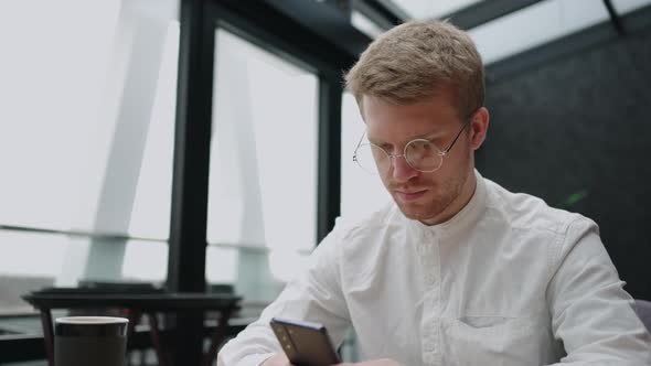 Social Media Addiction and Doomscrolling of Modern People Handsome Man is Viewing News Tape in