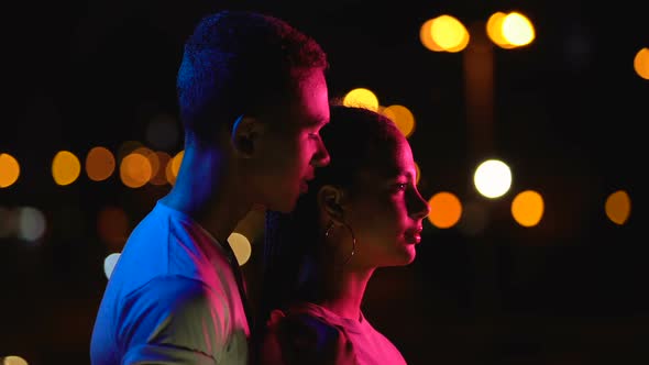 Happy Couple Looking at City Lights, Dreaming of Success, Saying Supportive Word