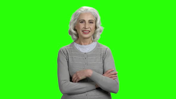 Senior Woman with Folded Arms on Green Screen