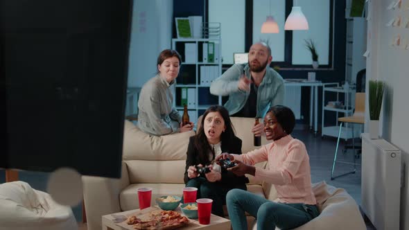 Colleagues Losing at Video Games on Console After Work