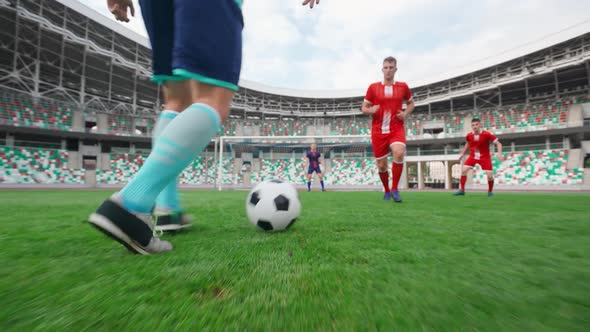 Training Day on the Football Field Young Guys Play Football on a Summer Day Man Bypasses the