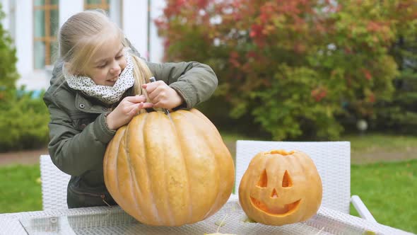 Cute Emotional Girl Carves Pumpkin Jack-O-Lantern Excited With Process Halloween