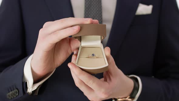 Groom Holding a Wedding Ring