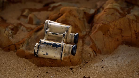 Old German Military Binoculars on the Sand Beach