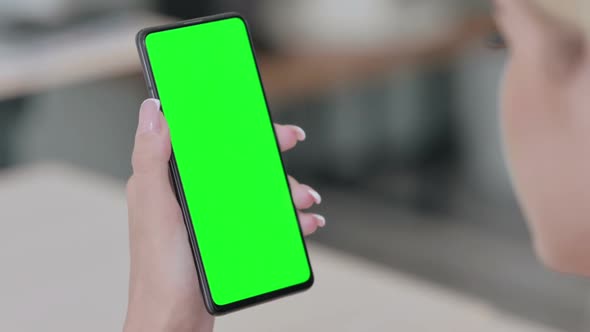 Close up of Young Blonde Woman Using Smartphone with Green Chroma Key Screen