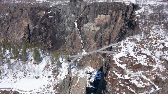 Spectacular bridge over deep canyon near Vøringsfossen waterfall at Fossli - Winter season experienc