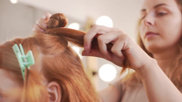 Female Hairdresser Making Hairstyle to Foxy Girl in Beauty Salon Slow Motion