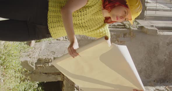 Vertical video of a girl engineer or archaeologist looking at the city destroyed by the earthquake