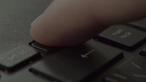 The Finger Presses the Backspace Button on the Keyboard