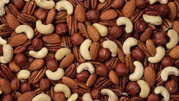 Mix nuts cashews, almonds, hazelnuts top view, rotate. 4K UHD video
