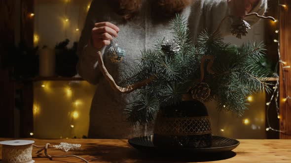 Young Woman Makes Christmas Ikebana