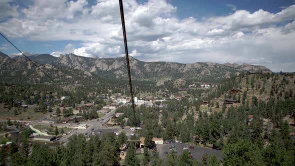 View from inside gondola going up mountain in mountain town