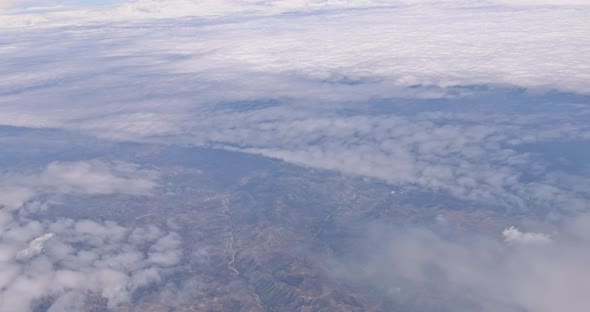 Airplane Wing View Out of the Window on the Cloudy Sky the Earth Background