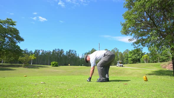 4K Asian senior man golfing at golf course on summer vacation