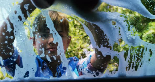 Girl washing her car in the garden