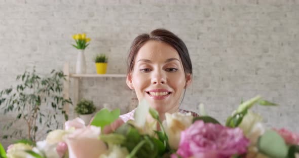 Young Girl with Closed Eyes Receives Bouquet of Flowers