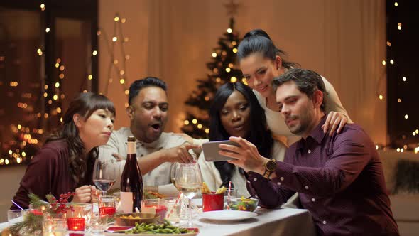 Friends Having Christmas Dinner with Spartphone