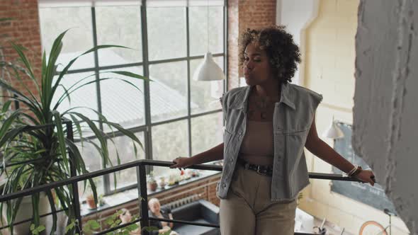 Woman Posing on Stairs in Coworking Place