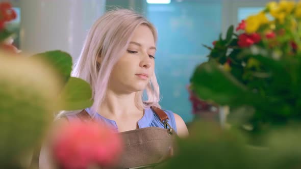 Flower Shop Consultant Observes Plants and Takes Notes