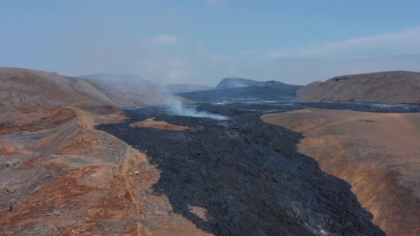 Scenic Aerial View of Black Lava River in Fagradalsfjall Iceland Drone Flying Backwards Reveal