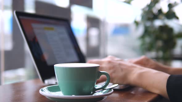 Close Up Of A Woman Hands Working With Laptop In Coffee Shop