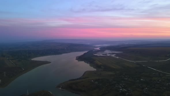 Aerial drone view of the Duruitoarea natural reservation at sunset in Moldova. River and village, hi