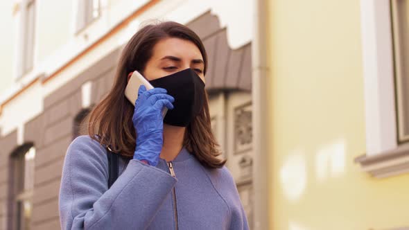 Woman in Face Mask Calling on Smartphone in City