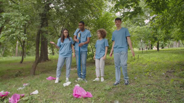 Activists with Litter Sticks Shocked By Pile of Plastic Trash Outdoors