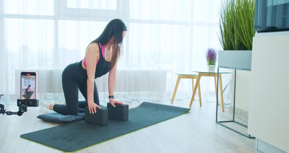 Brunette Woman is Doing Yoga Teaching in an Online Class Recording