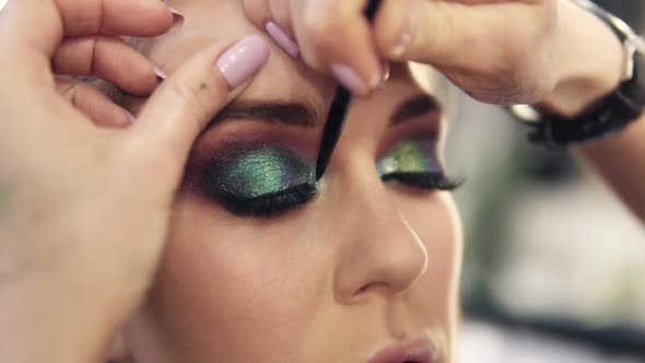 Final Touches of Visagist Work to Complete Green Eyes Make Up for a Gourgeous Woman