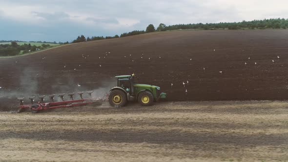 Agricultural Tractor Plows A Big Field