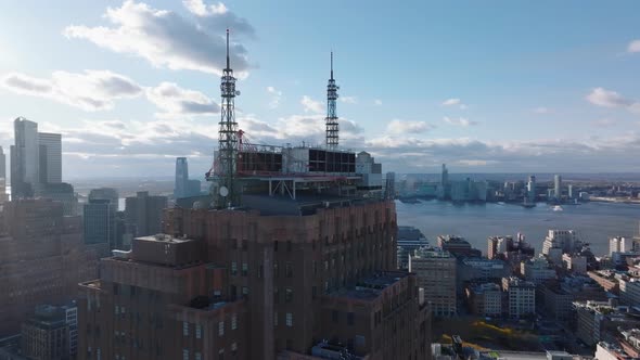 Orbit Shot Around Top of Tall Building with Steel Construction and Spires with Antennas