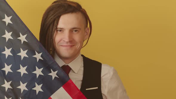 Young Man with American Flag on Yellow Background