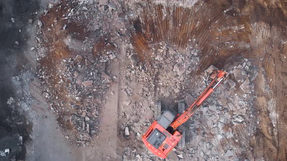 View From Above. A Large Excavator Dismantles the Concrete Base