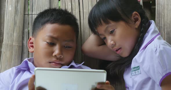 Asian Student Using Tablet In Cottage alt