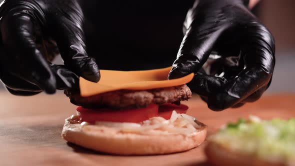 Closeup View of a Professional Chef Preparing Delicious and Juicy Burgers at a Fast Food Restaurant