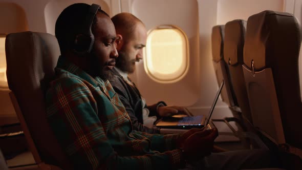 Tourist Using Mobile Phone and Flying on Airplane Jet