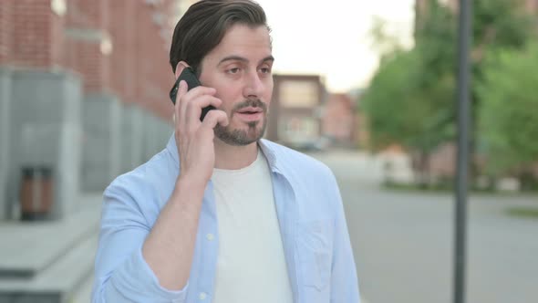 Man Talking on Phone While Standing Outdoor